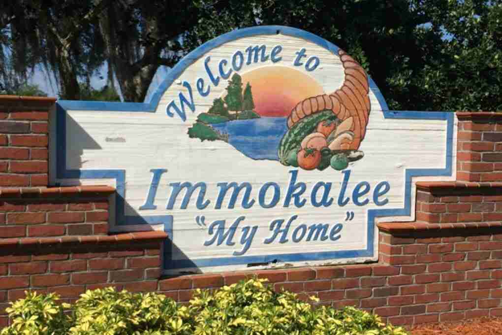Brick-framed sign reading Welcome to Immokalee, My Home